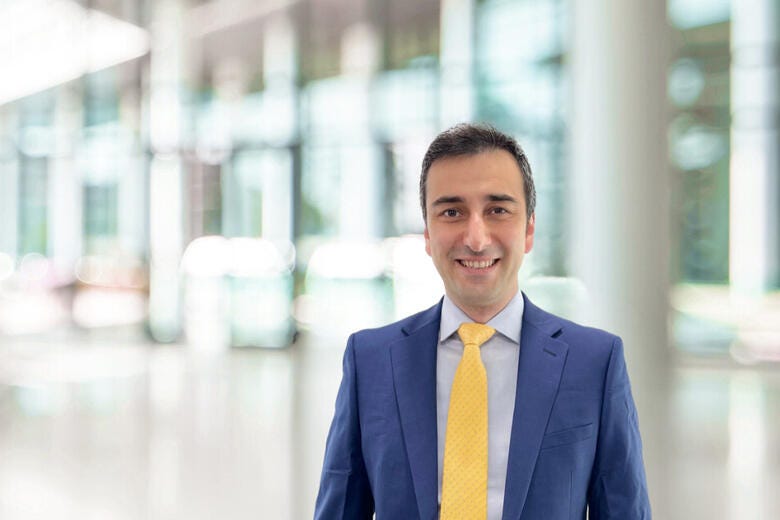 a man in a suit smiling