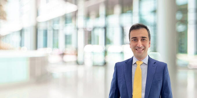 a man in a suit smiling