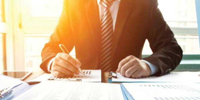 a person writing on a piece of paper