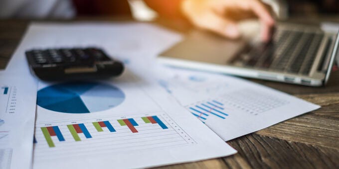 a close-up of a calculator and a paper on a table