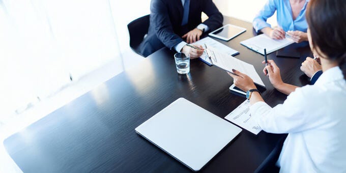 a group of people sitting around a table