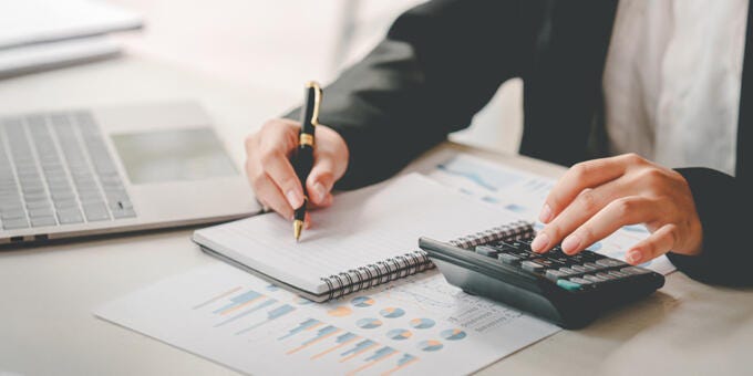 a person writing on a piece of paper