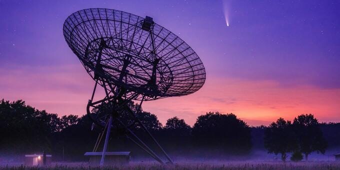 a large satellite dish in a field