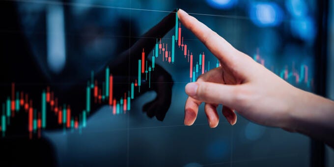 a hand holding a touch screen device