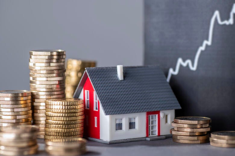 a small house on a stack of coins