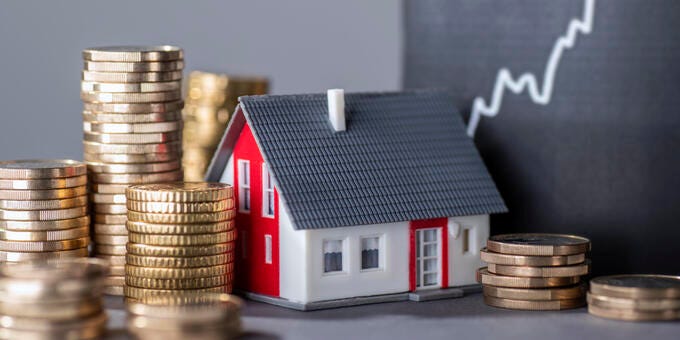 a small house on a stack of coins