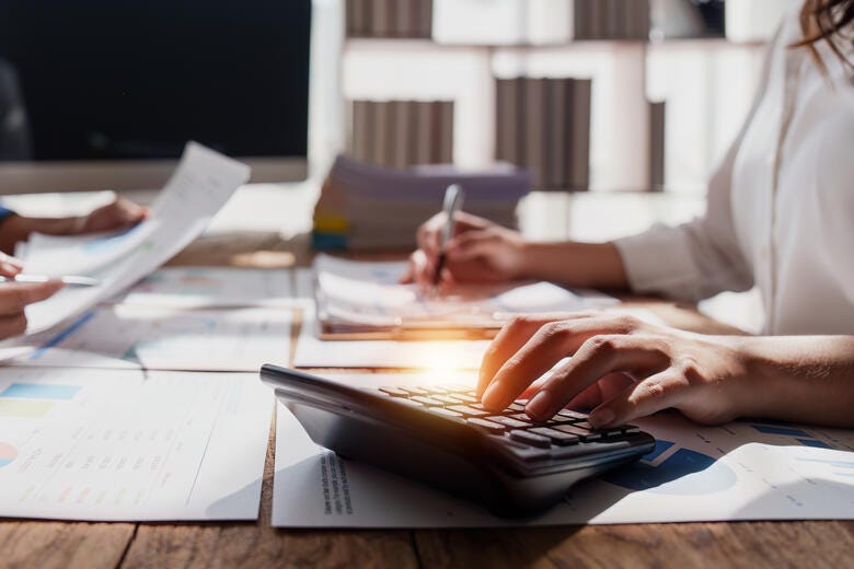 a person writing on a tablet
