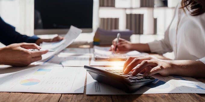 a person writing on a tablet