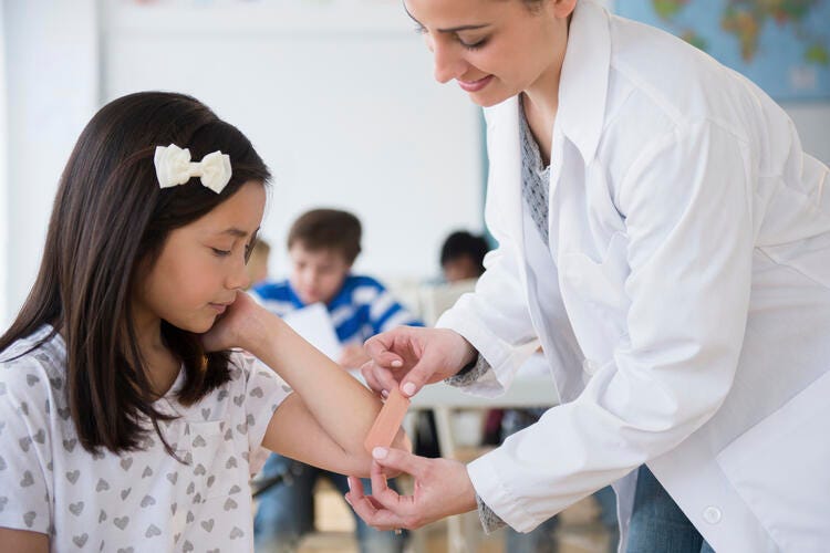 a doctor showing a young girl something on the tablet