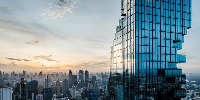 a city skyline with a sunset
