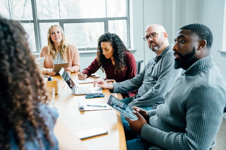 a group of people sitting around a table