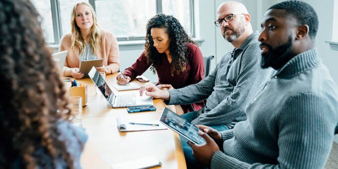 a group of people sitting around a table
