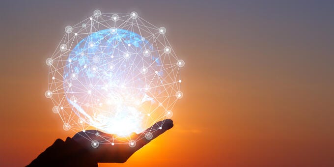 a hand holding a light bulb