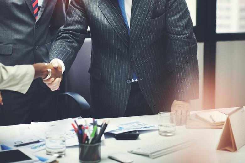 a few people shaking hands