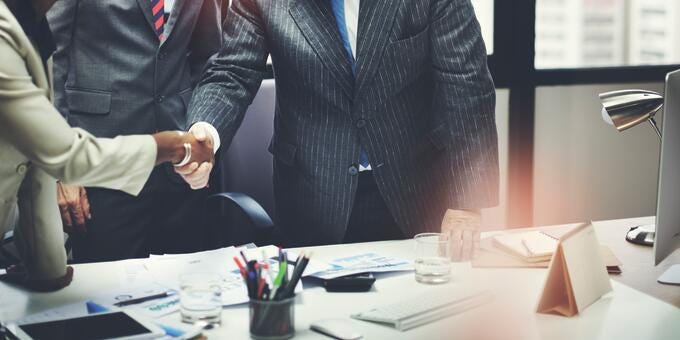 a few people shaking hands