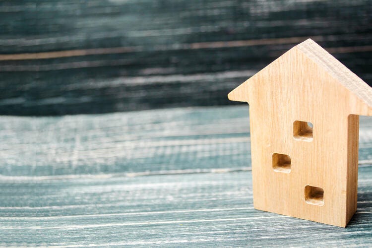 a wooden birdhouse on a wood surface