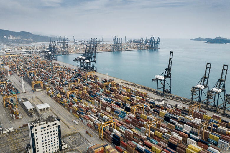 a port with many cranes and a large body of water