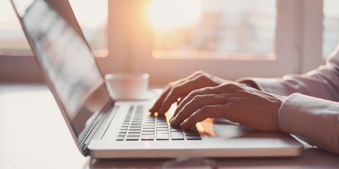 a person typing on a laptop