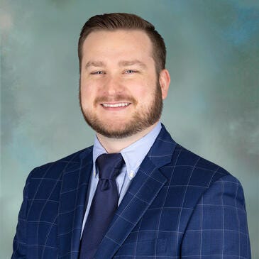 a man in a blue shirt and tie