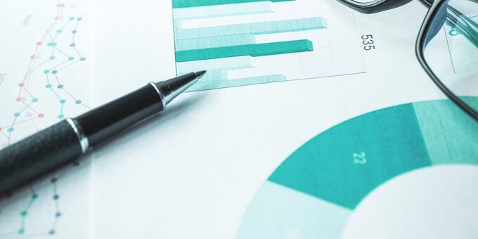 a pen and glasses on a table