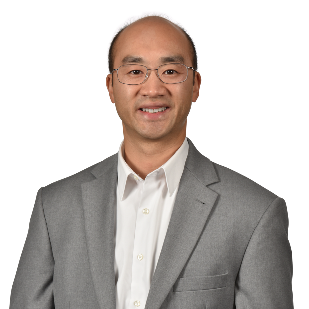 a man wearing a suit and glasses